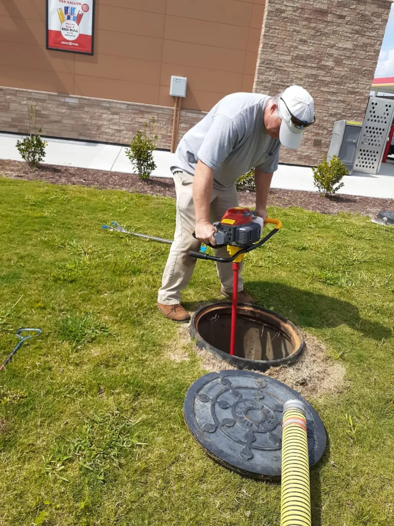 Septic service technician inspecting a system